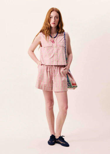 Sleeveless jacket in pink and beige gingham check from FRNCH with central button fastening. This light sleeveless piece is perfect for Summer worn casually with denim or shorts. It has a round neck and straight hem and two breast pockets. The fit is true to size.