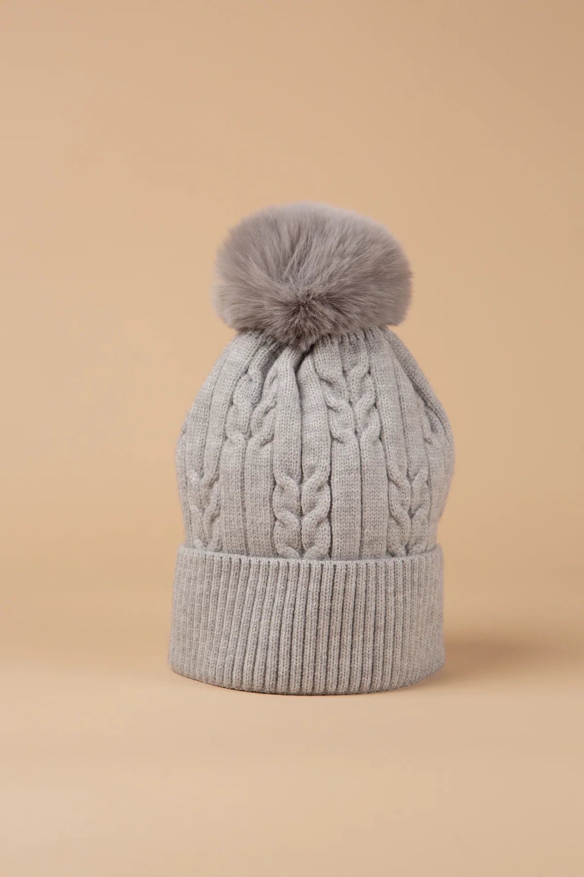Our ultra-cosy fleece-lined bobble hats feature a chunky knit design and are topped with a fluffy pom-pom. These hats are the perfect winter essential. Warm, soft, and snug, these hats are ideal for cold-weather layering. Available in other colours to suit every wardrobe.