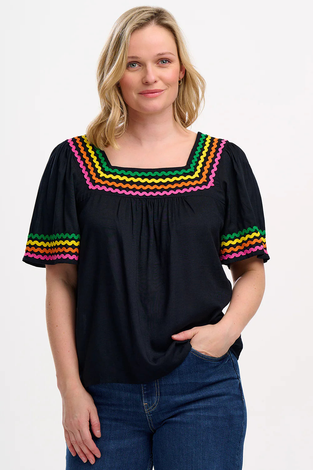 A Summertime essential from SUGARHILL, this sister style to our signature Alva Embroidered Top features rows of rainbow Ric Rac in green, yellow, orange and pink around the flattering square neckline. The Carmen top also features a relaxed fit and half-length blouson sleeves. The perfect top for those hot summer evenings.