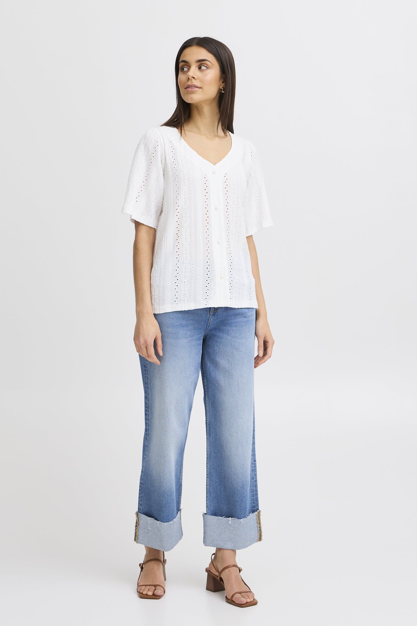 The Emira shirt from Scandi brand FRANSA is a great piece to wear with denim. A V neck blouse with short sleeves, it has pretty pearl buttons to close at the front. The hem is straight and the fit is true to size. The fabric is textured and embossed.