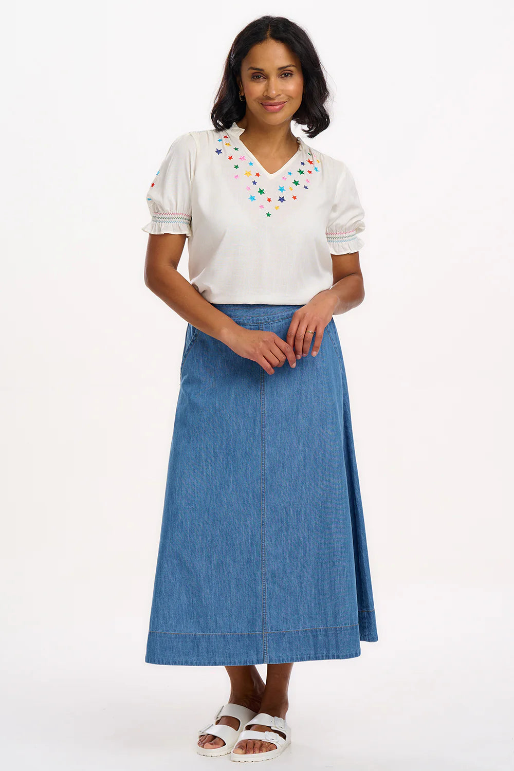 A simple Summer staple from SUGARHILL the Haydee Blouse is perfect for work or the weekend. The Haydee features rainbow stars embroidery around the neckline and on the sleeves, shirring on the shoulders, and frill collar, shirred frill cuffs and a flattering V-neckline.