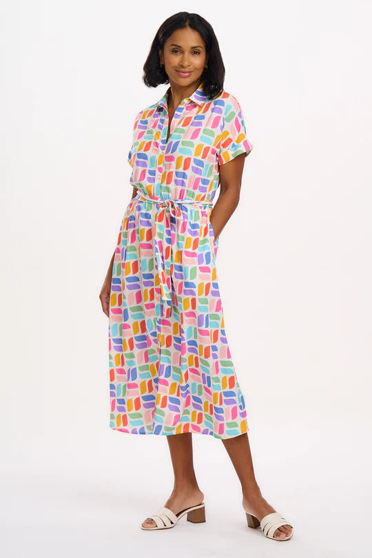 The Leigh dress from SUGARHILL has a traditional shirt collar and button placket falling into a full skirt with an elasticated waist. The Leigh's grown-on sleeves create a relaxed feel. Featuring our new Curved Geometric print of colourful retro shapes on an off-white base.