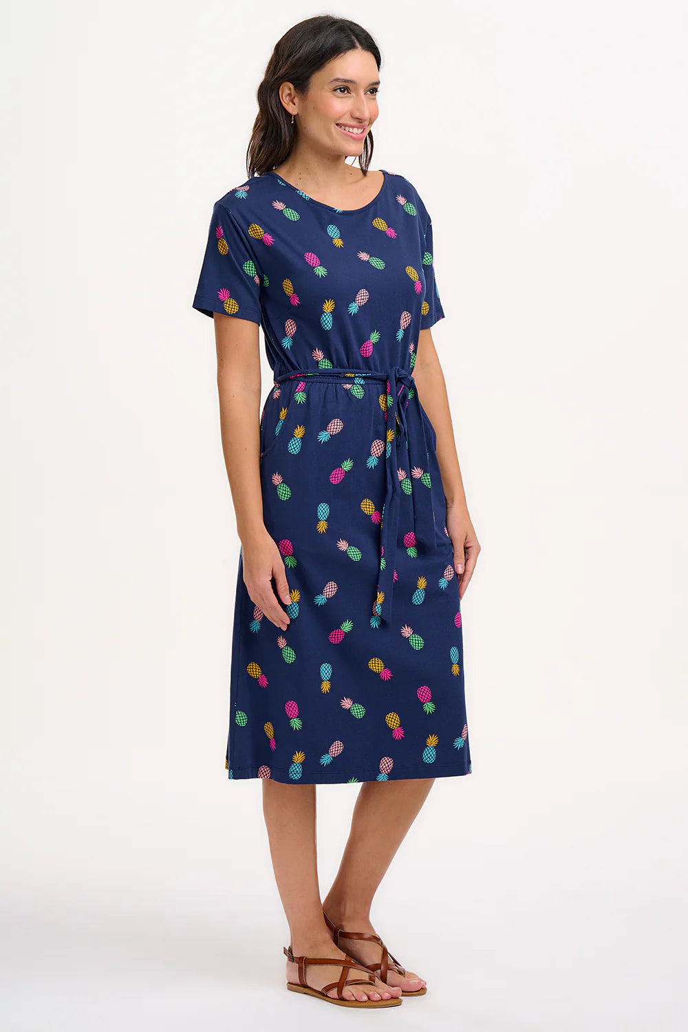 Introducing the new Moira dress from SUGARHILL. This updated style has a low scoop back for a more relaxed feel. Featuring our new playful Rainbow Pineapples print of colourful pineapples in yellow, baby pink, fuchsia, green and blue on a dark navy blue base.