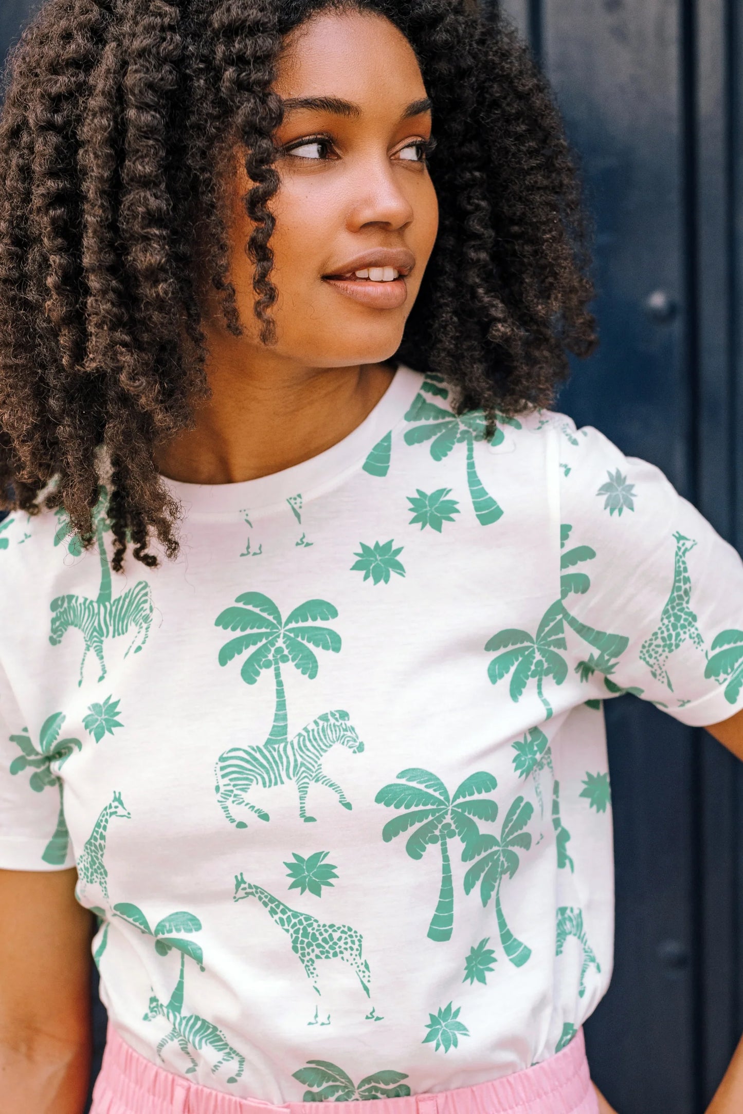 The Maggie from SUGARHILL has straight side seams and a straight back for a classic fit. We love the super soft 100% Organic Cotton base that makes this tee extra special. Featuring our new Savannah Oasis print of muted green Safari animals and palm trees on an off-white base.