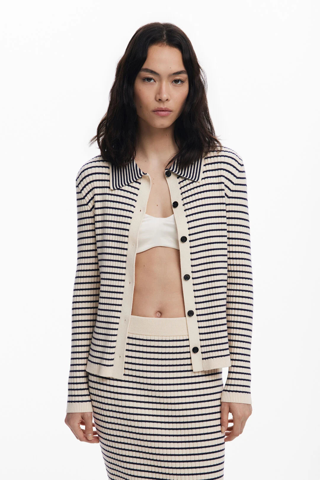 Fitted cardigan-style sweater from Spanish brand DESIGUAL with front buttons, polo-style collar, and horizontal stripe pattern. The fit is very neat