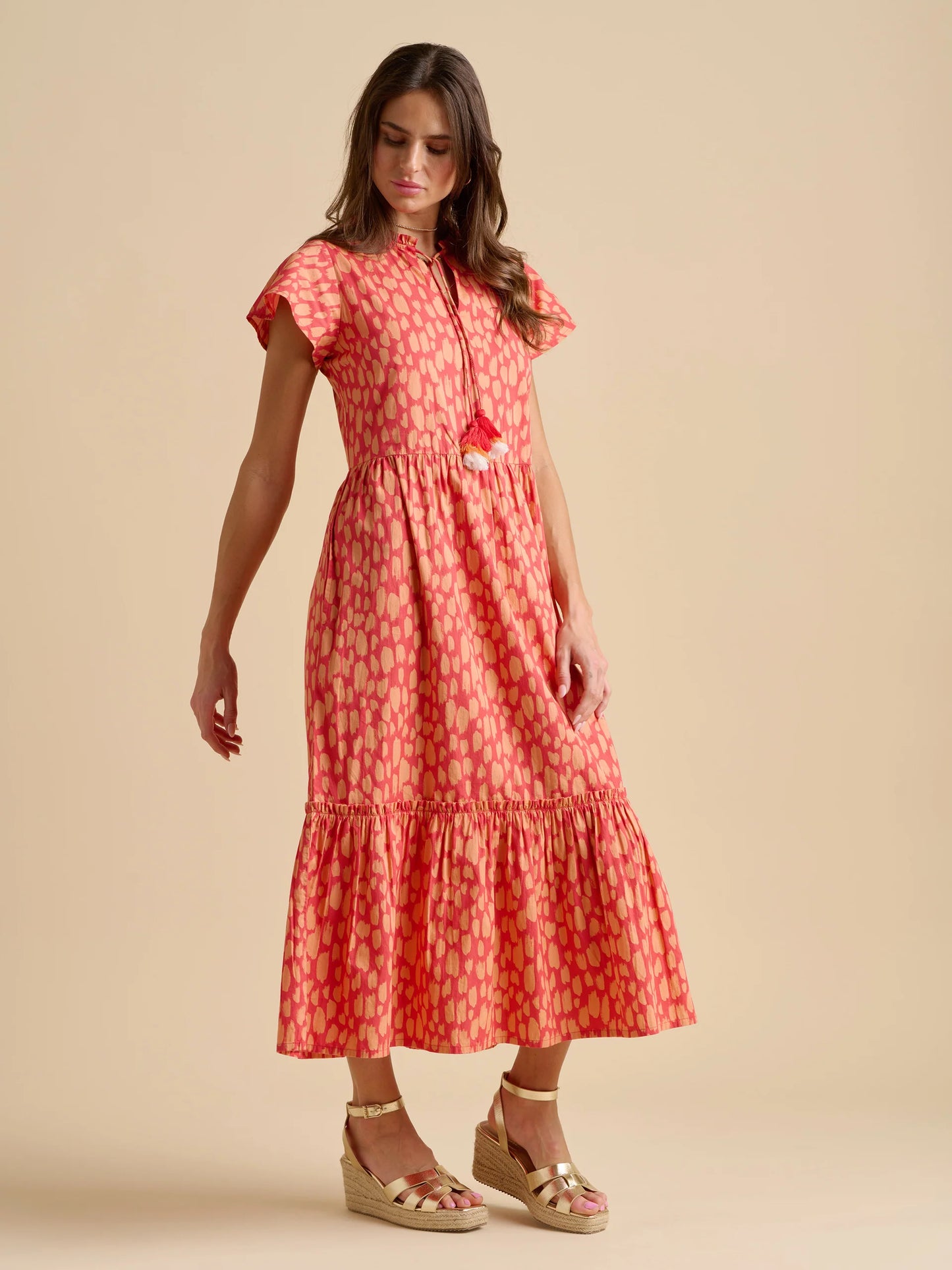 Capture the warm hues of a sunset wherever you are, with this dress from BRAKEBURN. The frill accents and tasselled neck ties add subtle details to this dreamy dress while hidden pockets up the practicality. There’s no better choice for sunset dates or evening strolls along the beach. Fits true to size.