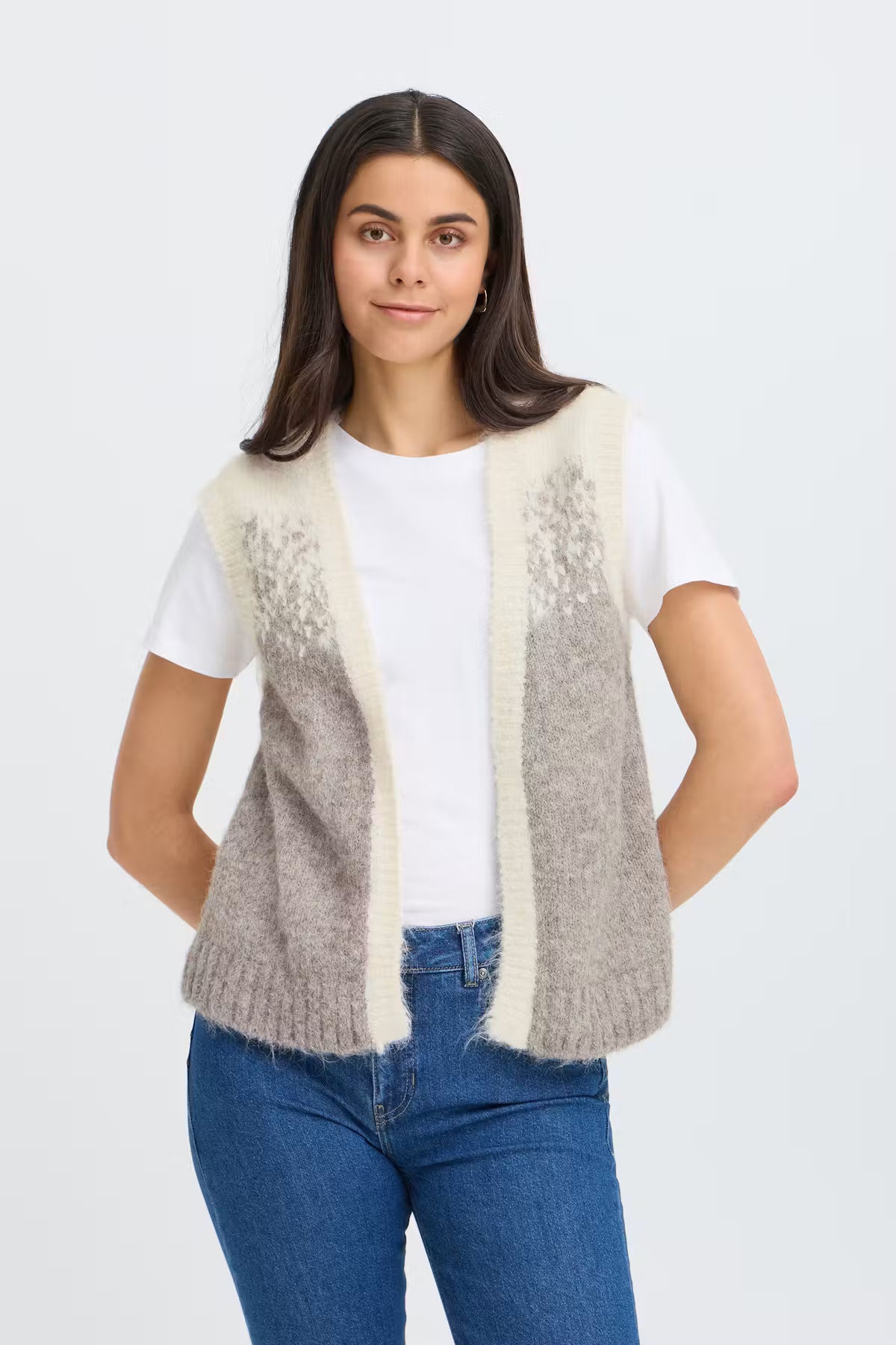Knit vest f from FRANSA eaturing a soft texture, open front, and straight fit. Wide ribbed edges and sleeveless design create a clean, modern silhouette. Perfect with denim or over a dress for extra warmth.