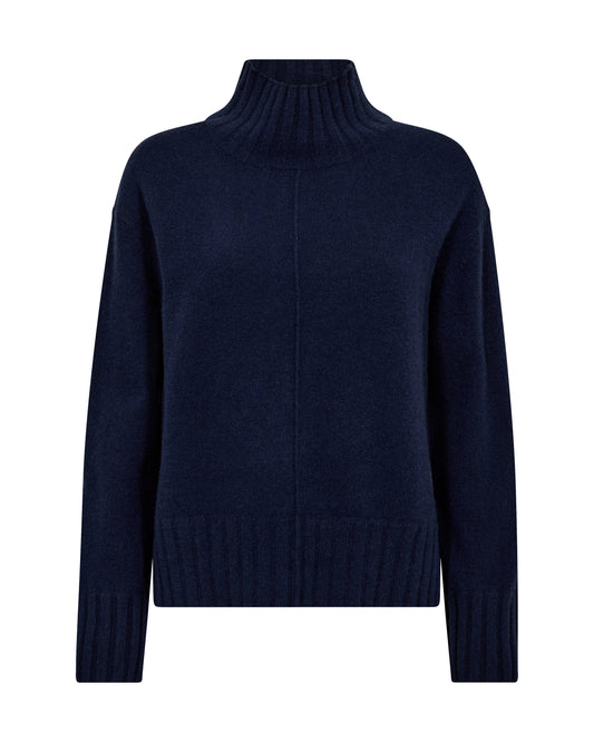Stay warm this season with this cashmere and wool knit from MOS MOSH. It has a slightly oversize fit and is finished with ribbed details on the high neck, cuffs, and bottom hem, and a raised seem detail down the front. It has a slit on each side, giving it a perfect fit to wear with wide leg jeans.