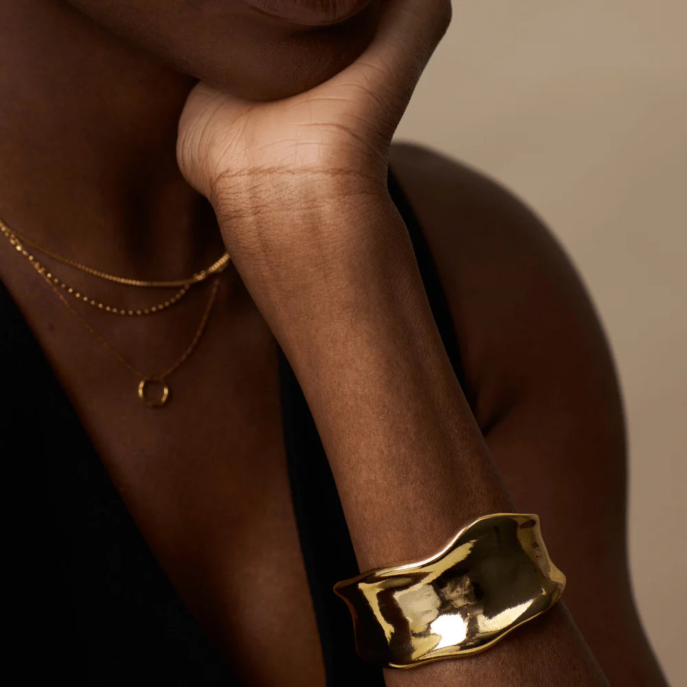 Add some drama to your outfit with this statement organic cuff in gold from ORELIA. Featuring a molten metal look this cuff is perfect for any outfit.&nbsp;