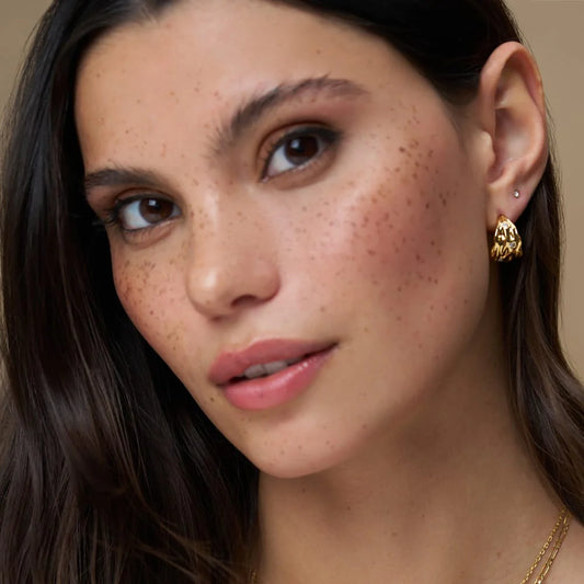 The Molten Crystal Tapered Hoop Earrings from ORELIA feature a chunky tapered silhouette with a softly molten texture, complete with few crystal details.