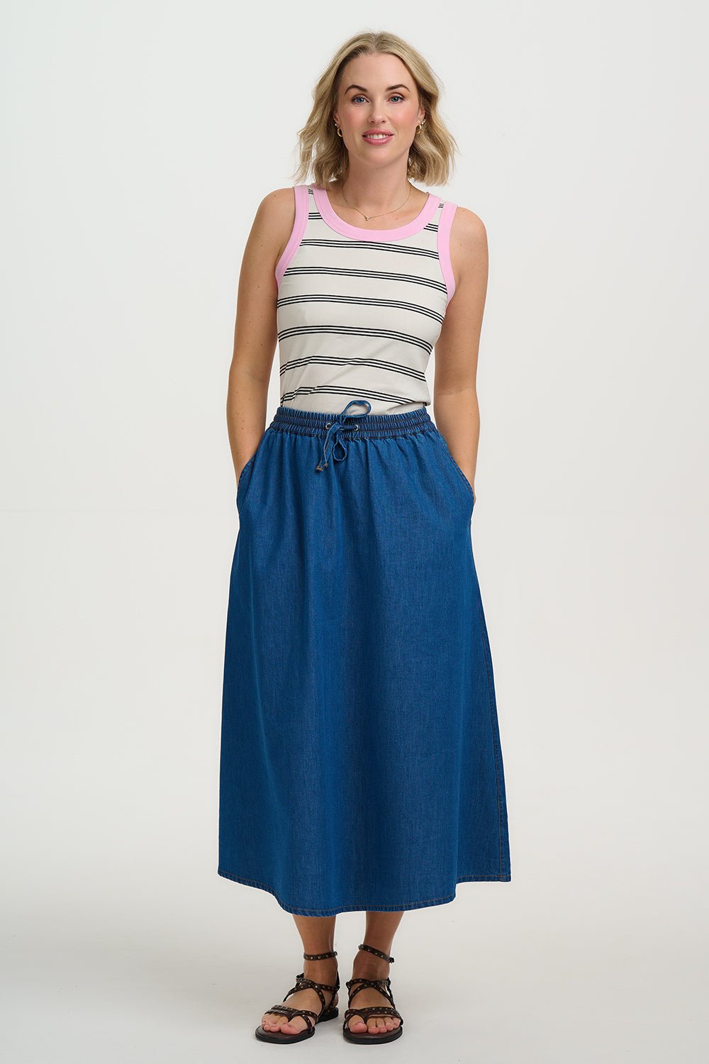 Effortlessly versatile and endlessly wearable, the Allegra Midi Skirt is crafted from soft, breathable 100% Responsibly Sourced cotton denim. Designed with a comfortable elasticated waistband and adjustable drawstring tie, it offers a flexible, easy fit that moves with you throughout the day. The gently flared midi-length silhouette creates a flattering, relaxed shape, while the lightweight denim gives it a soft drape and everyday comfort. Perfect for casual styling, pair with a simple tee and trainers