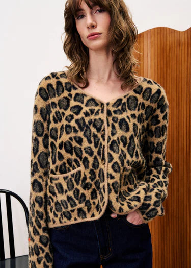 A stunning leopard print cardigan from Parisian brand FRNCH. This beautiful piece ticks all the boxes for any Winter wardrobe. Exuding style this knit is easy to wear from day to night if necessary. A soft V neck to flatter and contrasting buttons to fasten. The long sleeves have a soft beige trim. There are two patch pockets to the front and the boxy shape works really well with denim.