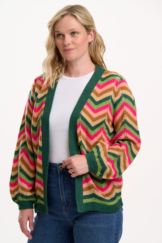New for 2025, the Bella Cardigan from SUGARHILL offers effortless style in a relaxed open-front silhouette with a flattering V-neckline. Crafted in a soft pointelle knit, this bold cardigan features an eye-catching chevron zigzag pattern in earthy greens, pinks, and browns, infused with textured dot detailing for added interest. With no fastenings, Bella mirrors the fit of our bestselling Yvette — a versatile statement knit perfect for layering over basics or denim.