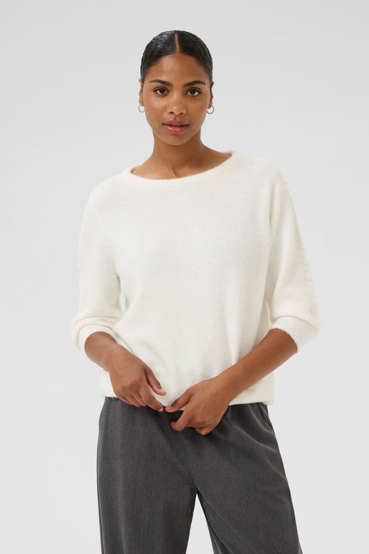 Women's sweater from KAFFE with relaxed fit, round neckline and decorative button details along the sleeves. Designed for versatile occasions and everyday comfort, perfect for both work and casual wear.