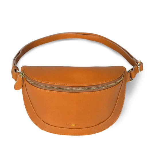 Our best selling LIBERTY crossbody bag is hand-made in our new super soft caramel leather with gold colour trims. Perfect enough to carry your daily essentials, with an inside zip pocket to help keep you organised, wear across your body or over your shoulder.