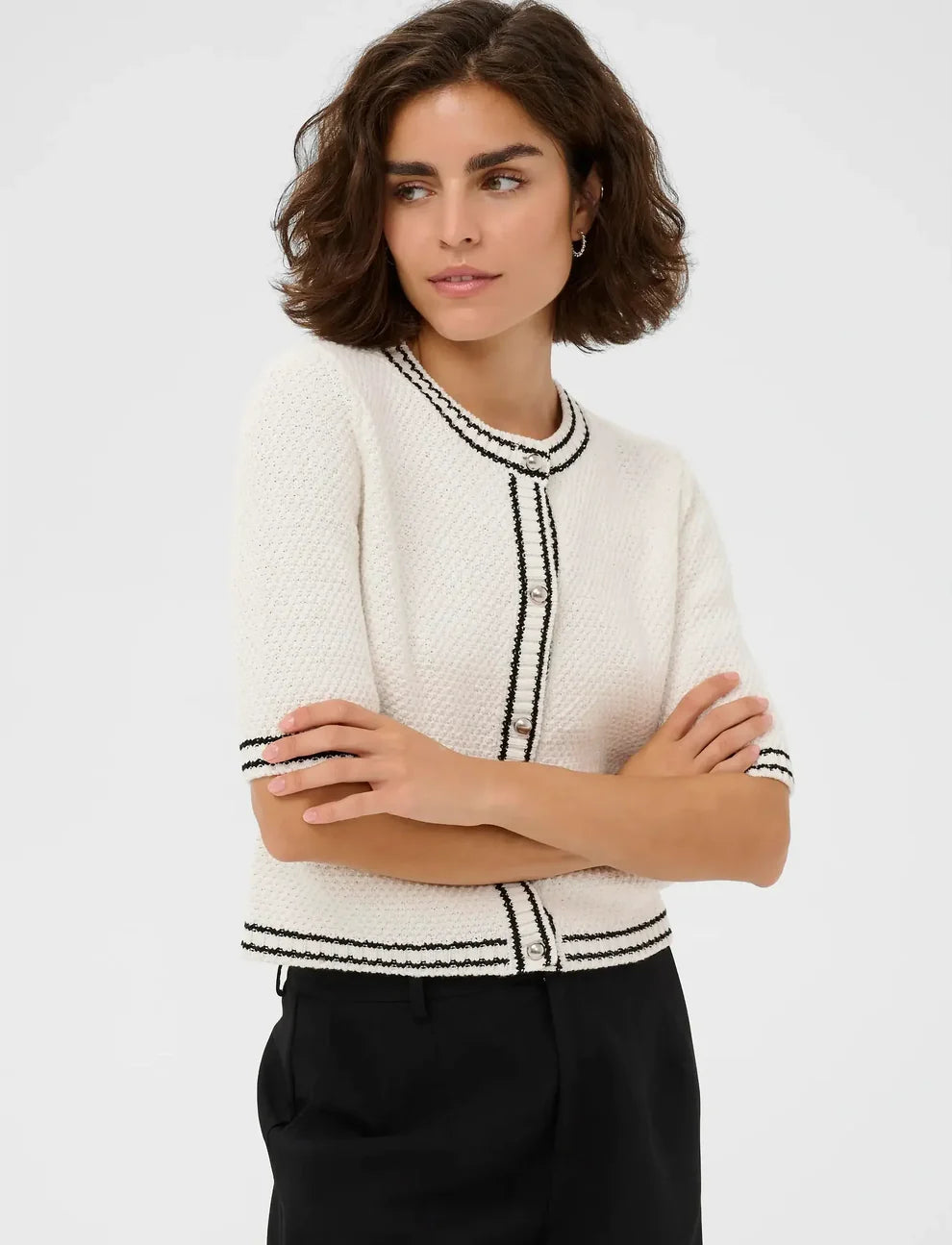 Offering a refined look, this knit cardigan from KAFFE features a round neckline and front button closure. The design is completed with practical front pockets and elegant contrast trim. The fit is not generous.