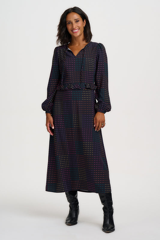 A modern take on the classic polka dot, this dress from SUGARHILL proves that print doesn't have to shout to make an impact. A hypnotic all-over spot print with a digital edge, rows of evenly spaced dots in a shifting spectrum of pink, teal, gold, lilac, and peach glow against a deep black background,