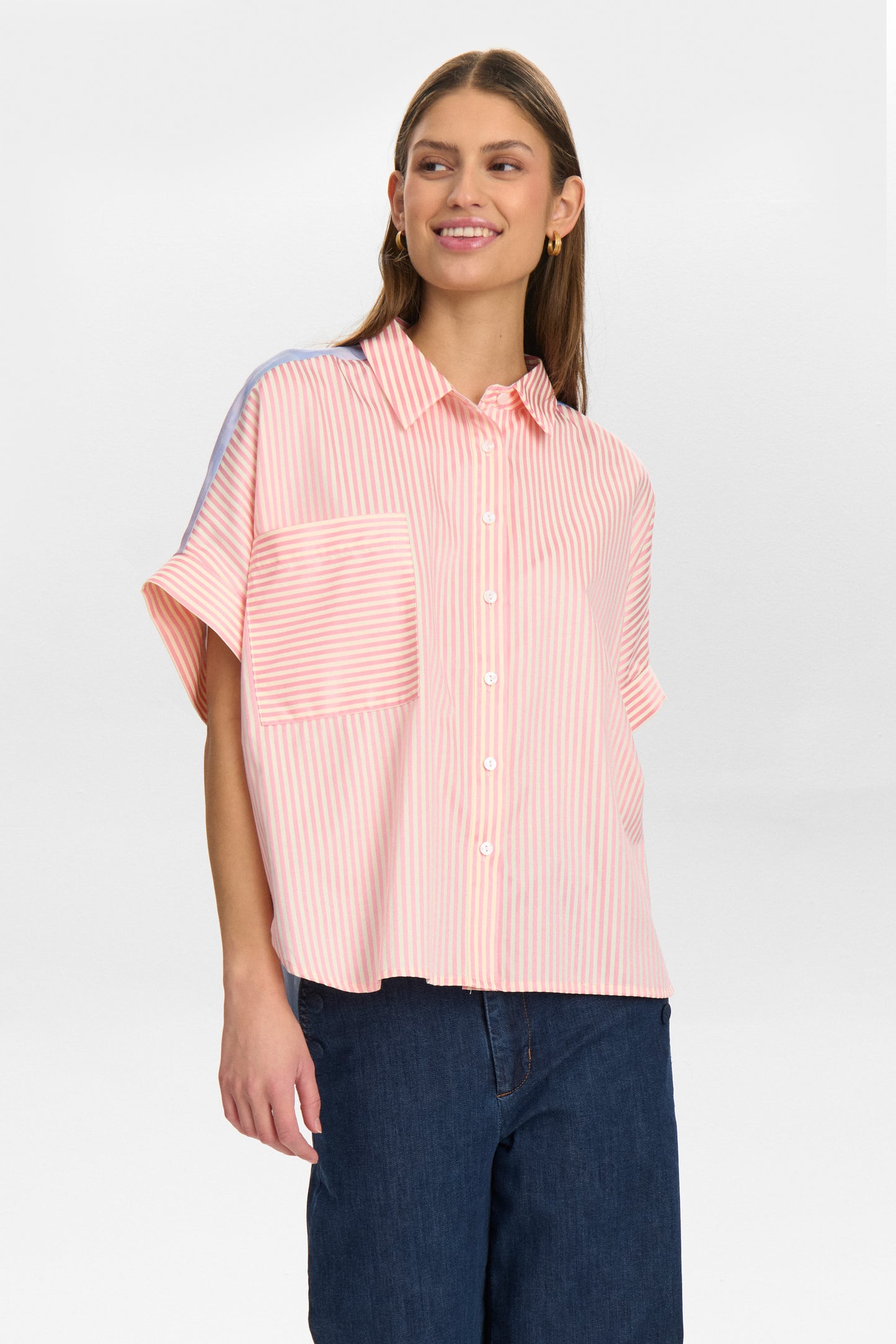 The NUDiamond shirt by Scandi brand NUMPH is a conversation piece. In a silky feel fabric the front of the blouse is a pink and cream stripe but on the back is a striking sky scene in the prettiest blues. There is a classic shirt collar with buttons to the hem and the dropped shoulders have short sleeves with a small turn up. The fit is oversized.