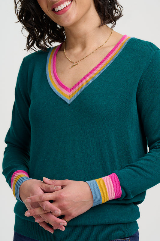 The Doris V-Neck Knit from Sugarhill is a soft and versatile style with a flattering V-neckline, long sleeves and a playful rainbow trim detail. The colourful rainbow edging adds a fun pop to the V-neck and cuffs, making this an easy-to-wear knit with a cheerful twist.
