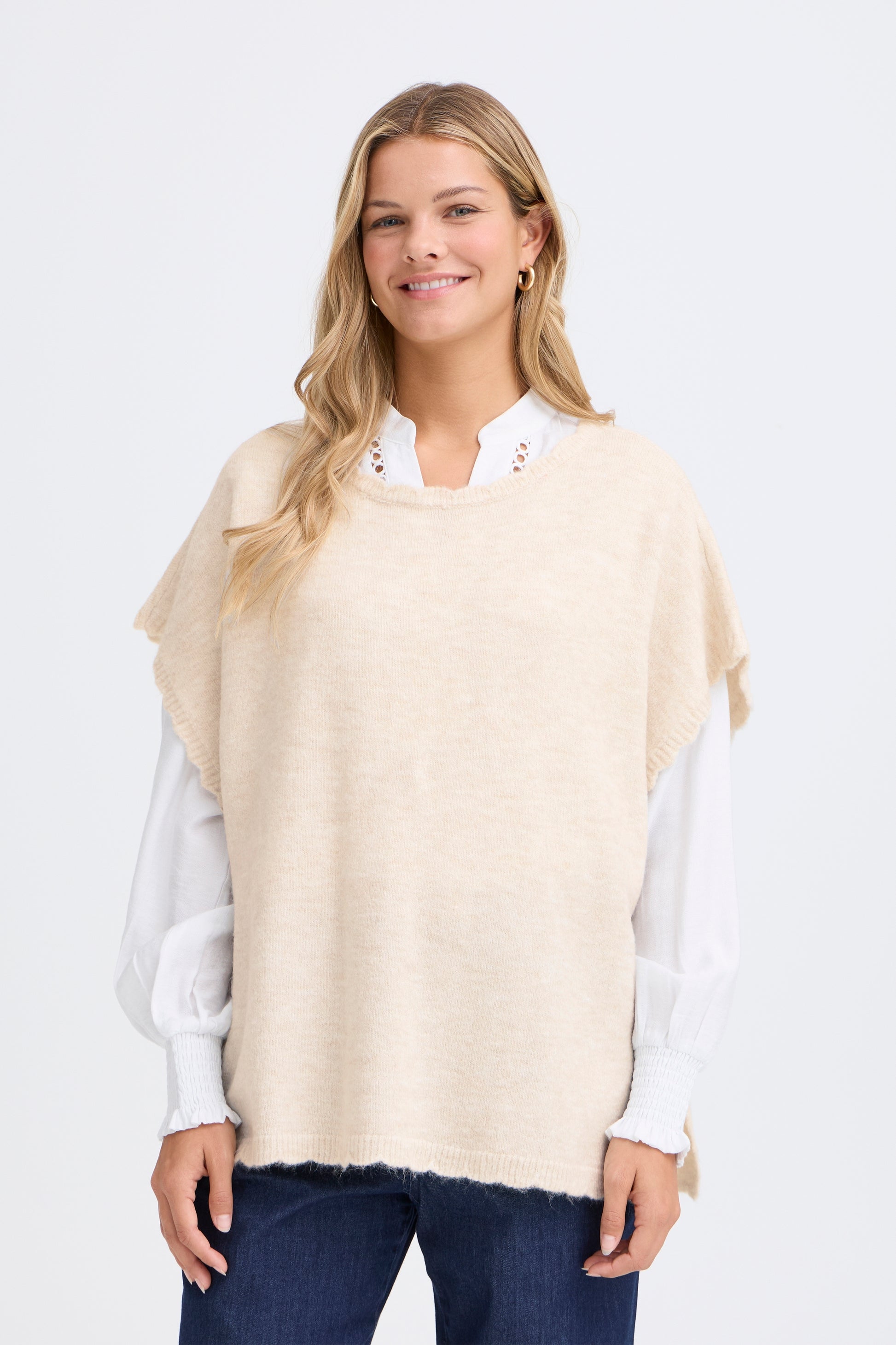 A one size poncho style knit from FRANSA in two great neutrals. Pull over the head to add a simple layer in Spring time. The edges are scalloped for that point of difference and the neckline is a classic round neck.The ribbed hem is straight. The fit is oversized.