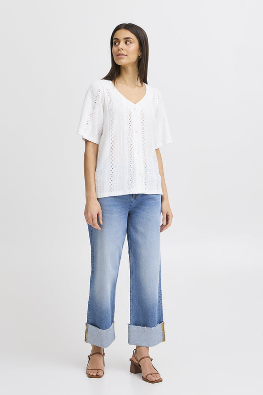 The Emira shirt from Scandi brand FRANSA is a great piece to wear with denim. A V neck blouse with short sleeves, it has pretty pearl buttons to close at the front. The hem is straight and the fit is true to size. The fabric is textured and embossed.