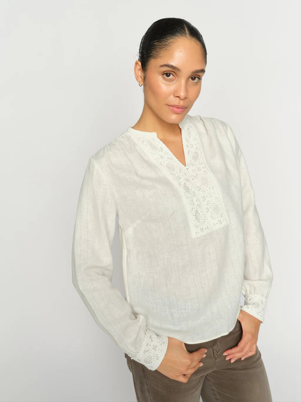 A beautifully detailed blouse from MOS MOSH crafted from a soft linen-cotton blend. Designed in a relaxed silhouette with delicate broderie anglaise along the neckline and cuffs, adding a touch of elegance to the natural texture. Pair it with tailored pants or denim for a refined yet effortless look.
