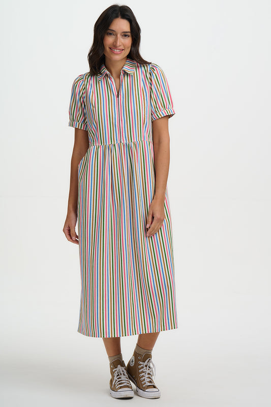 The Gillian Dress is an effortlessly feminine midi crafted from breathable 100% organic cotton. Designed with a flattering collared neckline and zip-front detail, it combines classic tailoring with everyday comfort. The softly gathered waist creates a gentle, flowing silhouette, while the short puff sleeves add subtle shape. Finished in a fresh colourful pinstripe with practical side pockets, it’s the perfect balance of polished and relaxed. Style with sandals or trainers for easy daytime wear, or layer wit