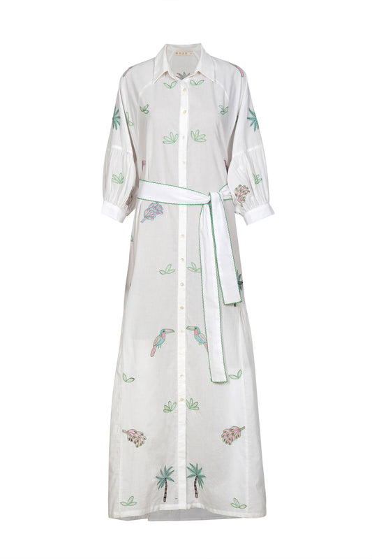This gorgeous dress from BRDR is perfect for a summer occasion. A long maxi length shirt style dress in pure white with stunning multi coloured embroidery on the front and the sleeves. Gentle pleats at the side from below the waist add a little fullness to the skirt. The full bracelet length sleeve has slight gathers and a cuff with single button. There is a white cotton fabric belt with blanket stitching in bright green to finish. The dress is very light so comes with a short slip in cotton.