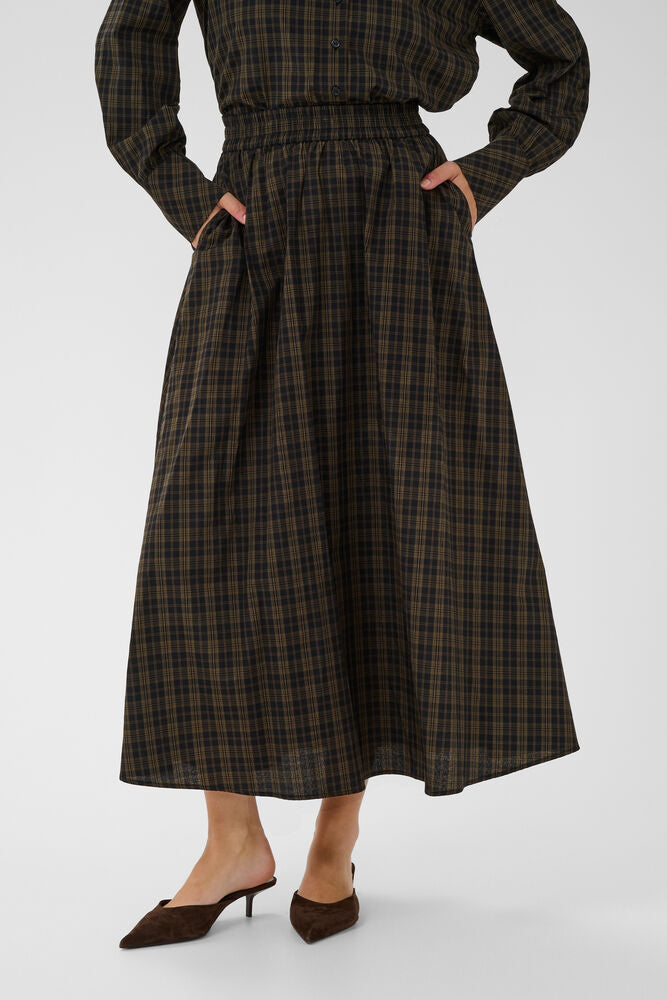 Midi skirt from Scandi brand KAFFE with a softly structured, full silhouette and subtle all-over plaid texture. Features an elastic waistband and a relaxed fit, finished with a flowy hem that moves easily. The fit is true to size.