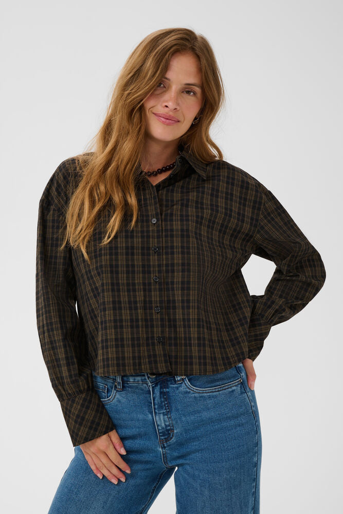 The KAHelie shirt from KAFFE is a boxy fit, classic pointed collar, full button front and long sleeves with wide cuffs. Features an all-over check pattern and a cropped length. Wear with denim or the matching skirt.