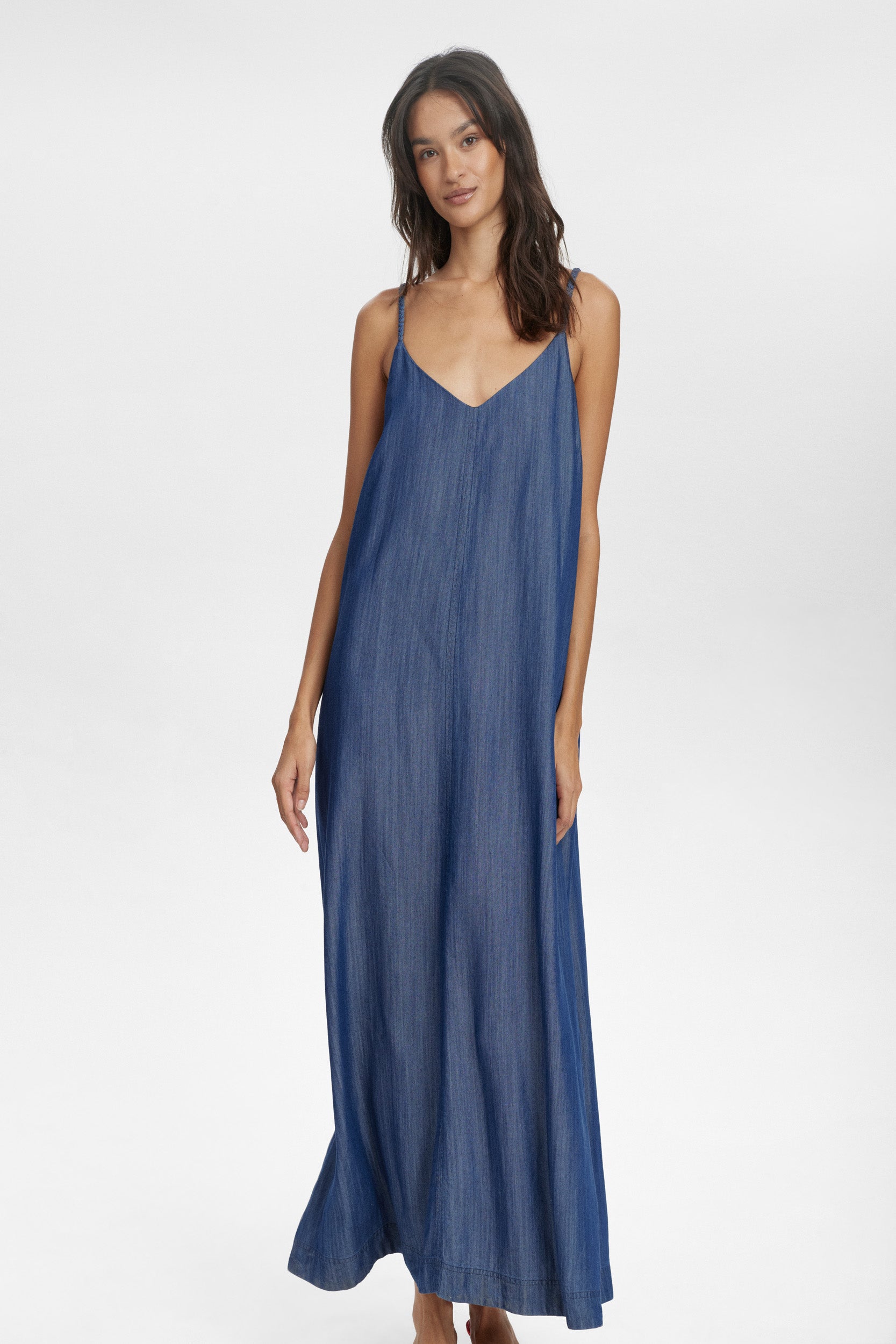 This stunning slip dress from Scandi brand NUMPH is in a beautiful denim look fabric. With a flattering V neck and plaited slim straps this maxi dress will work hard for you over the warmer months. There are also pockets in the seem to add that extra special touch. The fit is true to size.