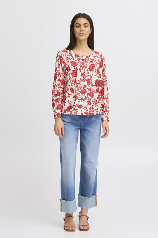 A great blouse from Scandi brand FRANSA in a stunning red and ecru print. The round neck top with a half placket with button . There are pin tucks either side of the placket The long sleeves have a cuff and single button fastening.The hem is straight and the fit is true to size.