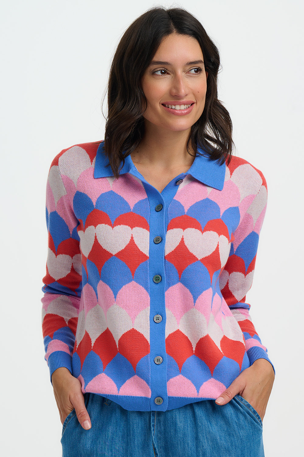 This standout cardigan from SUGARHILL brings playful retro charm to your knitwear collection. Designed with a flattering semi-fitted shape, button-through front and classic collar, it features a bold scalloped heart pattern in vibrant shades of orange, blue, pink and cream. Soft to the touch and easy to style, it’s perfect for adding colour and personality to everyday outfits.