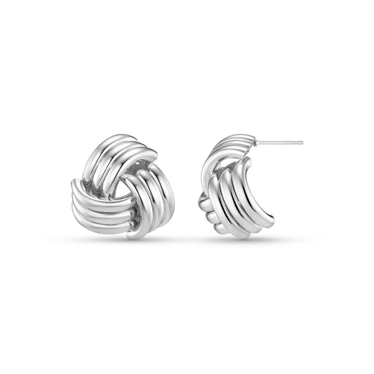 Bold yet refined, the Interlocking Statement Stud Earrings in silver bring sculptural elegance to everyday wear. Each earring features seamlessly entwined curves that create a striking dimensional silhouette.