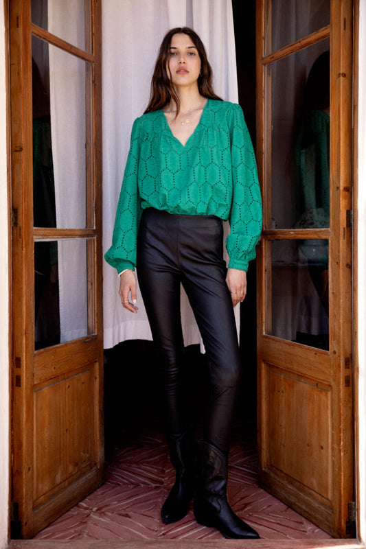 A bright statement piece from Scandi brand Atelier Reve. This V neck blouse has long sleeves with a single button cuff. It is in a broderie anglais fabric at the front and a plain fabric at the back. A great transitional piece to wear going in to Spring.