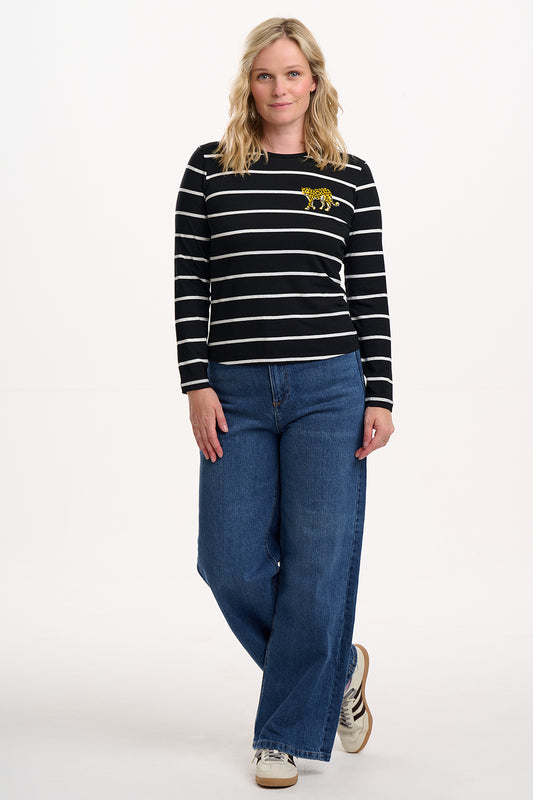 Refresh your wardrobe with the Josie Jersey Top from SUGARHILL in black and white stripe. Featuring high-contrast, white horizontal stripes on a black base, this long-sleeve top offers a clean, modern take on classic Breton style. The highlight of this top is the embroidered leopard on the bust. Crafted from soft, breathable jersey fabric, it’s perfect for layering or wearing solo for effortless everyday style. Pair with jeans for a casual weekend look or tuck into the matching skirt for a polished fi