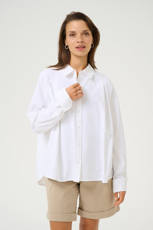 A chic white blouse from KAFFE for Spring that works beautifully with a pair of shorts as well as denim. The dropped shoulder is super flattering and the slight pleating on the front adds that point of difference. The long sleeves have a long cuff that can be worn down or turned back. There is a simple shirt collar and rounded hem. The fit is true to size.