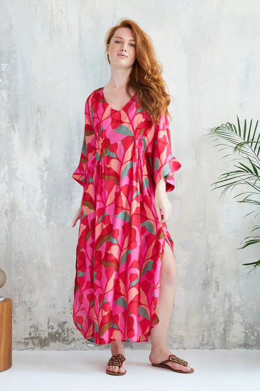 The Kaili dress from French brand CHICO SOLEIL is perfect for Summer with its floral print in vibrant colours. The fluid kaftan style dress is light and airy and has a bohemian feel. There is pleating in the middle of the back and at the front to add a touch of elegance. Perfect for a Summer event. The fit is true to size.