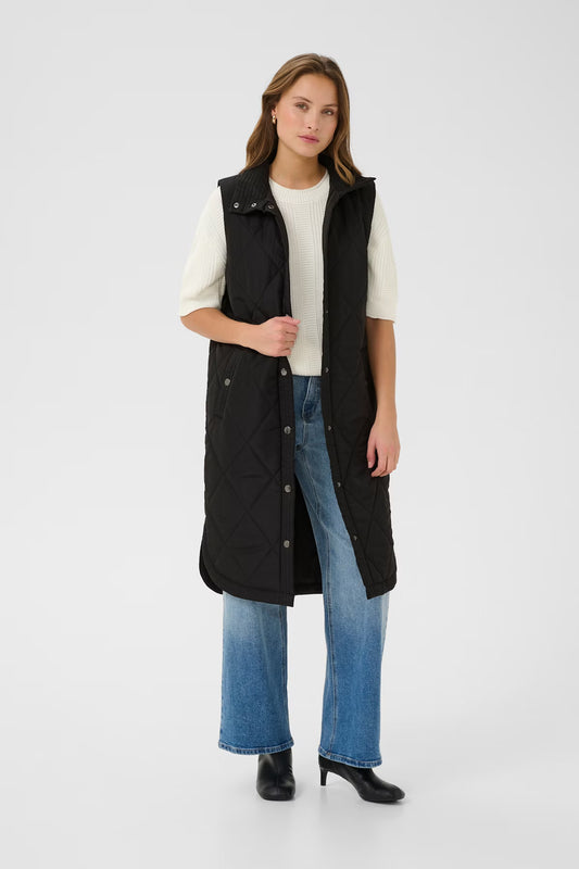 The quilted vest from KAFFE features a straight, elongated silhouette with a high stand-up collar, snap-button front, and side welt pockets. Diamond-pattern stitching and a smooth finish add effortless edge to this sleeveless layering piece.