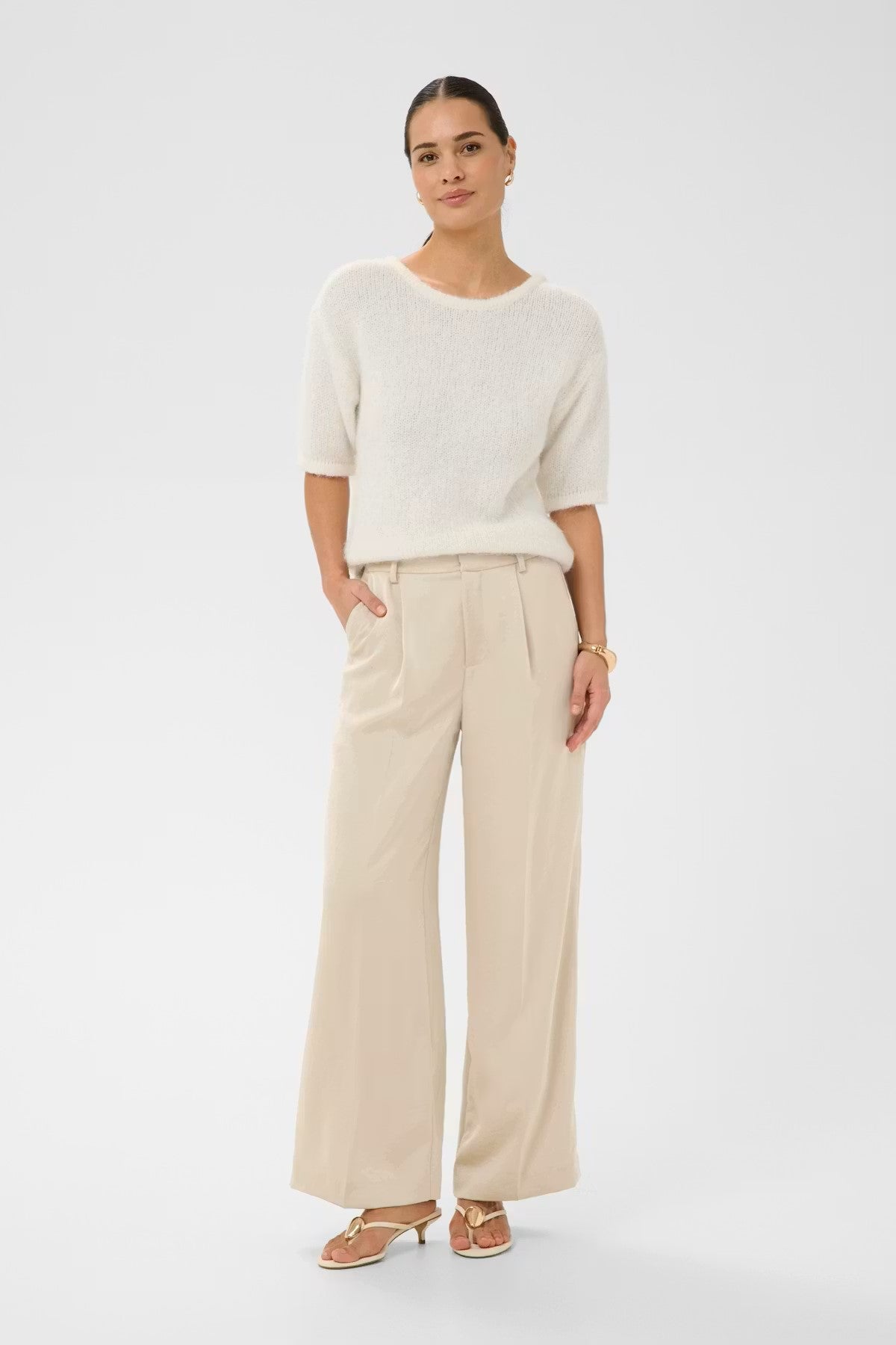 Wide-leg trousers from Scandi brand KAFFE feature a fluid, straight silhouette with pressed front pleats and belt loops, finished with a structured waistband and full-length cut. A stunning trouser for any occasion or to wear casually with a trainer and T shirt.