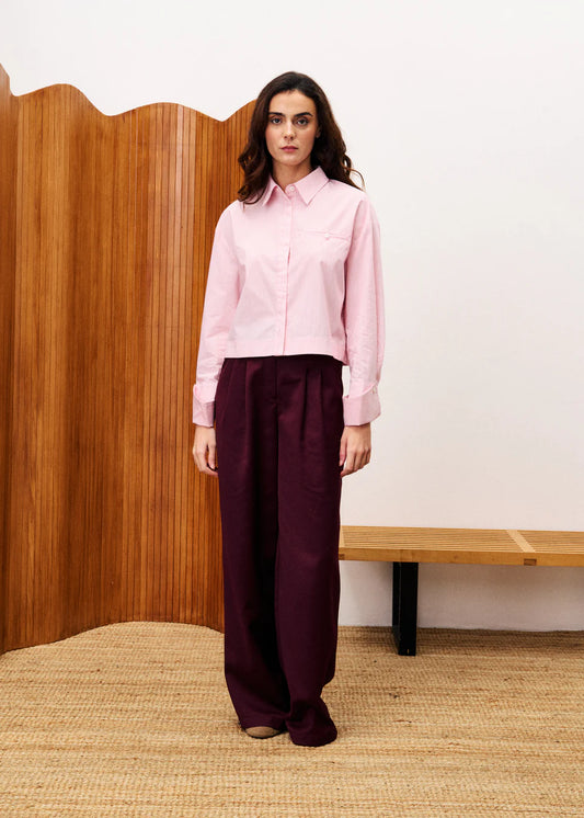 This is a super smart cropped shirt in a delicate stripe from Parisian brand FRNCH . With a classic collar this stylish piece is great worn with a wide leg jean. The buttons are hidden under a pleated placket and the hem is slightly longer at the back than the front. The long sleeves have a statement cuff which has a large cuff cut on the angle and buttoned either side.