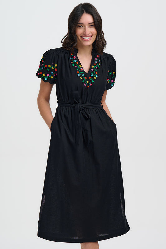 A super pretty midi dress in classic black from SUGARHILL Brighton. The pretty notch neck is trimmed with coloured floral embroidery and the shoulders are gently gathered. The short sleeves are puffed and elasticated and embroidered too. The waist is elasticated and there is a self tie belt and side pockets. The fit is true to size.