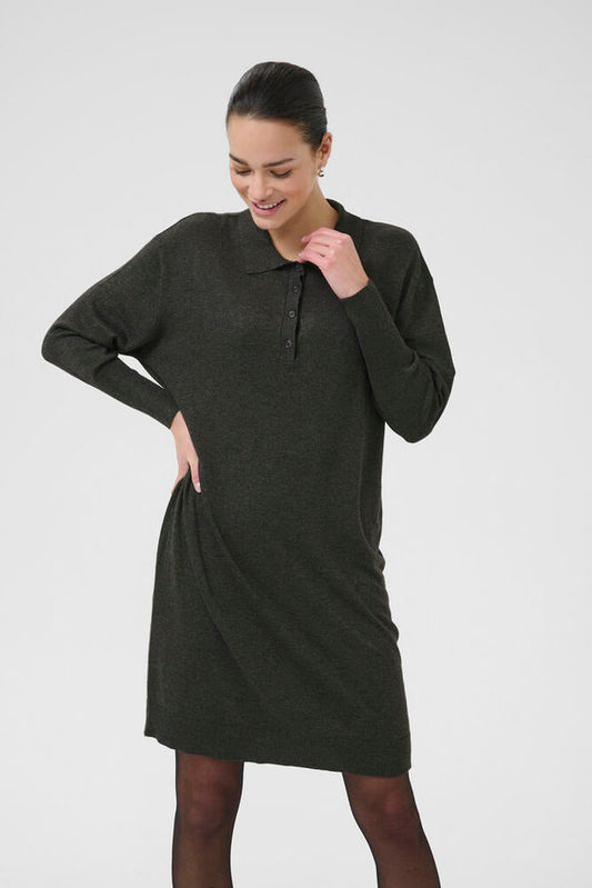 A simple shorter length knitted dress from Scandi brand KAFFE in a dark grey melange. The perfect work dress is fairly fine knit with a collar and button to half placket. The long sleeves are fitted and have a ribbed cuff.