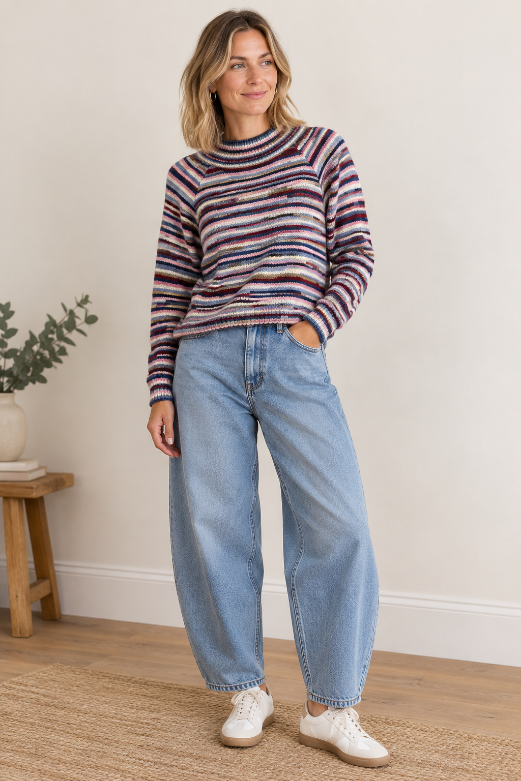 Striped knitted sweater from 24 COLOURS in warm shaged of pink, blues, cream and burgundy. The knit features a high stand-up collar, long raglan sleeves and a straight, loose cut. Ribbed cuffs and the fine stripe structure complement the design