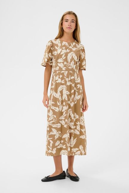Midi dress from KAFFE featuring a straight silhouette, round neckline and short sleeves with subtle gathers at the shoulder. The surface has a smooth matte finish, and the dress displays an all-over large botanical motif. Back zip closure is present.