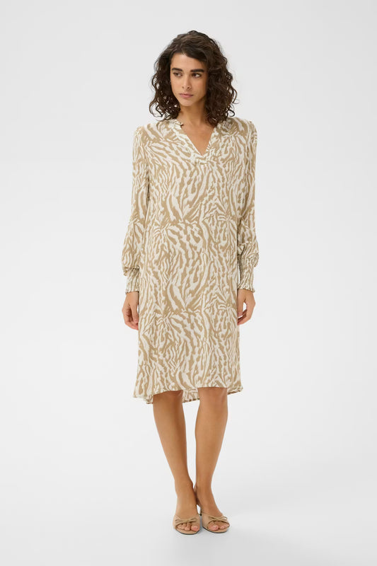 This neutral print shorter dress from KAFFE features a straight silhouette, V-neckline with subtle ruffle trim, and long voluminous sleeves with wide, gathered cuffs for easy elegance. The fit is true to size .