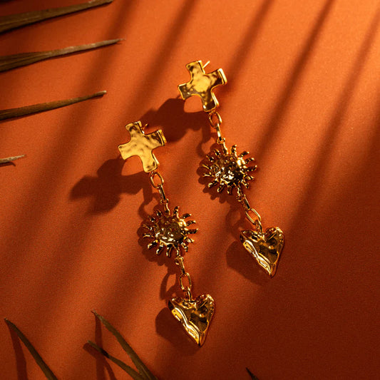 Designed to turn heads, featuring sculptural, charm motifs, the Molten Statement Charm Drop Earrings. Pair with a minimalist outfit to let the texture speak for itself. These playful earrings showcase a statement drop design with a high-polish, molten finish, giving them a liquid-like shimmer that catches the light from every angle.