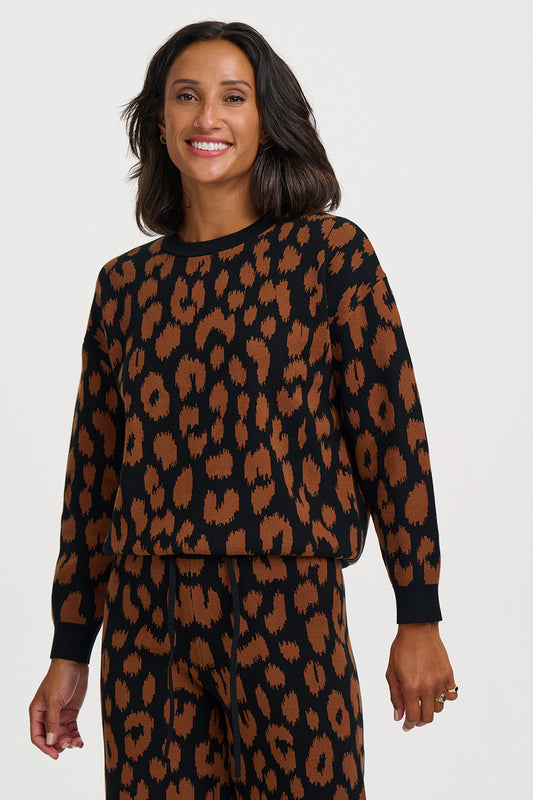 A leopard print done properly, this jumper from SUGARHILL brings a bold and timeless animal print with a painterly twist. Classic leopard spots in rich chocolate brown are rendered with a slightly textured, brushed edge against a deep black background, giving this wardrobe staple a raw, instinctive energy.