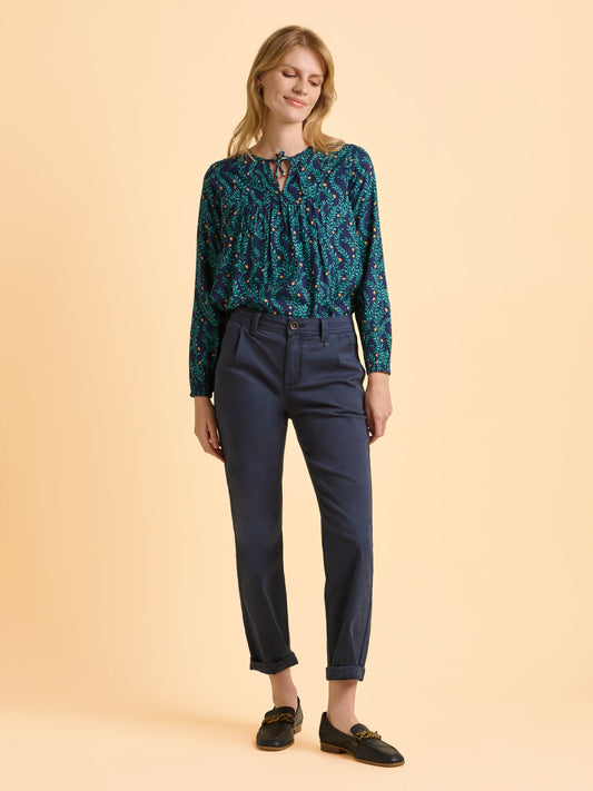 This gorgeous new teal coloured blouse from British brand BRAKEBURN is a must for this Autumn/Winter. Round neck with a little tie which can be worn open or tied. The long sleeves are gently elasticated at the cuff. The navy background on the leaf style print shows off the contrast teal and gold colours perfectly. The fit is true to size.