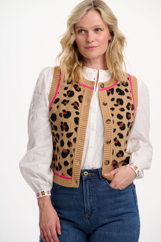 Add a wild touch to your layering with the Natalie Knitted Waistcoat from SUGARHILL, crafted in a warm tan knit with bold natural leopard spots. This sleeveless cardigan features a classic button-front fastening, a ribbed trim, and playful hot pink tipping for a modern twist. Designed for easy styling, it's the perfect transitional piece to wear over dresses or tees. A standout knitted vest that adds texture and print to any outfit.